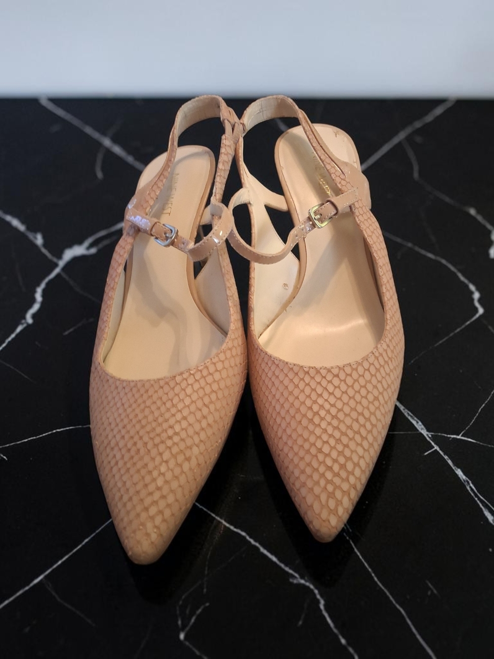 Nine West Kookie slingback pumps featuring a beige snake-print texture. Size 10